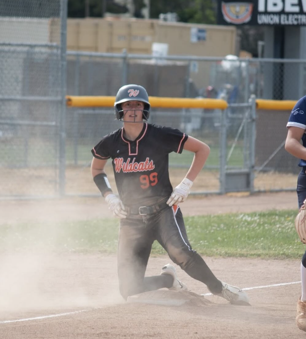 Junior Mo Overbey taking a big slide onto third base and posting up for the picture.